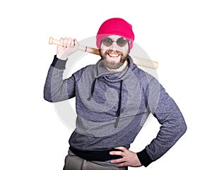 Fashion hipster cool man in sunglasses and colorful clothes brandishing a baseball bat