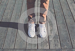 Fashion hipster cool man with white sneakers, soft vintage toned