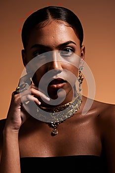 Fashion, jewellery and portrait of woman in studio for designer, luxury cosmetics and accessories. Beauty, aesthetic and