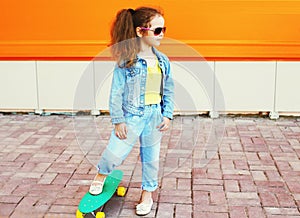 Fashion kid concept - stylish little girl child wearing a jeans