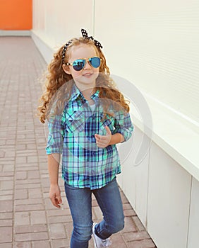 Fashion kid concept - stylish little girl child wearing a shirt