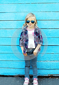 Fashion kid, stylish child wearing a sunglasses