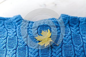 Fashion knitted handmade pullover sweater for the baby boy or girl with balls of wool and knitting needles