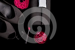 Fashion Lady Accessories Set. Black and pink. Minimal. Shoes, bracelet, perfume, lipstick and bag on black background. Flat lay.