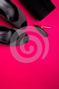 Fashion Lady Accessories Set. Black and pink. Minimal. Black Shoes, lipstick and bag on pink background. Flat lay.