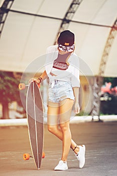 Fashion lifestyle, beautiful young woman with longboard