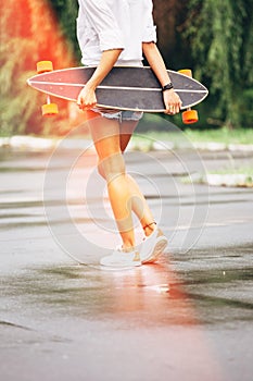 Fashion lifestyle, beautiful young woman with longboard