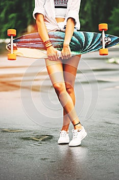 Fashion lifestyle, beautiful young woman with longboard