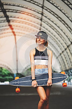 Fashion lifestyle, beautiful young woman with longboard