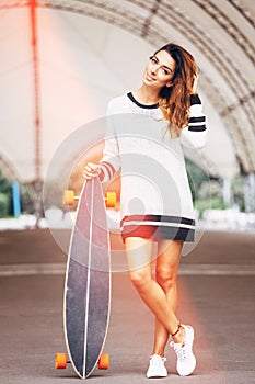 Fashion lifestyle, beautiful young woman with longboard