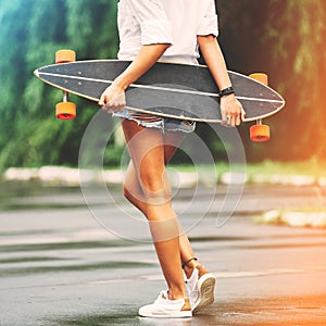 Fashion lifestyle, beautiful young woman with longboard photo