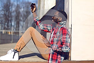 Fashion lifestyle photo happy young african man makes selfie