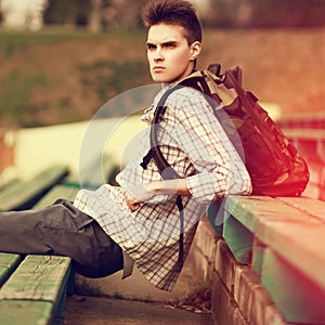 Fashion lifestyle portrait of handsome hipster man with backpack