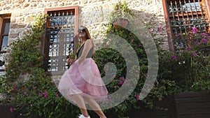 Fashion lifestyle portrait of young funny woman in tulle skirt