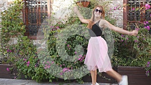 Fashion lifestyle portrait of young funny woman in tulle skirt