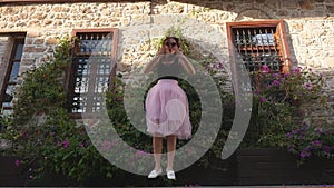 Fashion lifestyle portrait of young funny woman in tulle skirt