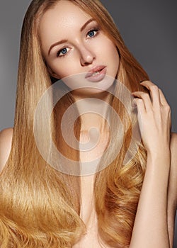 Fashion long hair. Beautiful blond girl. Healthy straight shiny hair style. Beauty woman model. Smooth hairstyle