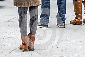 Fashion look of girl dressed in casual style in short skirt and broun boots