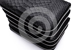 Fashion luxury snakeskin python black wallets isolated on a white background.