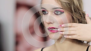 Fashion madness woman smearing burgundy lip gloss
