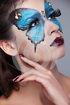 Fashion Make up. Butterfly makeup on face beautiful woman. Art P