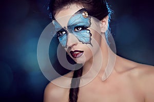 Fashion Make up. Butterfly makeup on face beautiful woman. Art P