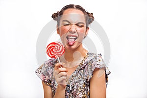 Fashion makeup. Beauty Girl Portrait holding Colorful lollipop. Hot red lips. Nail polish manicured nails. Skin care