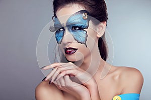 Fashion Makeup. Butterfly face art woman Portrait.