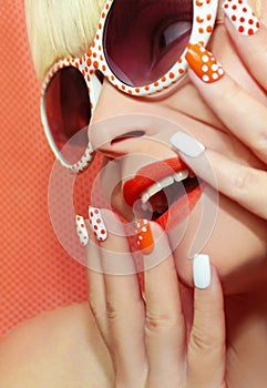 Fashion makeup and manicure orange color.