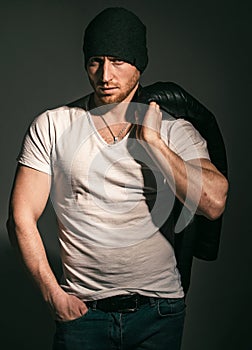 Fashion male model. Studio shot of young man looking at the camera. Handsome guy with confident face. Mens sexuality or