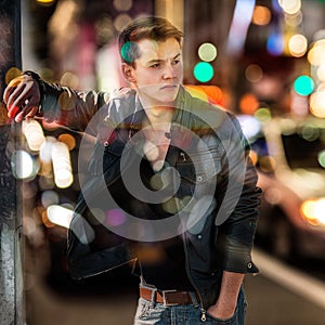Fashion man in blurred background of New York night car traffic