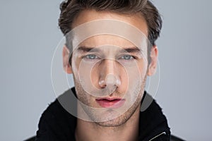 Fashion man face close up over gray background