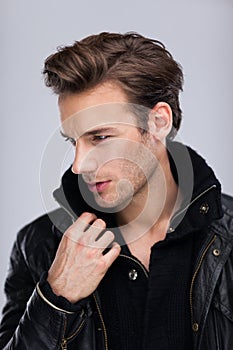 Fashion man face close up, over gray background