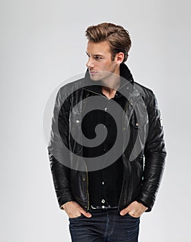 Fashion man, model leather jacket, gray background