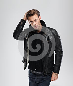 Fashion man, model leather jacket, gray background