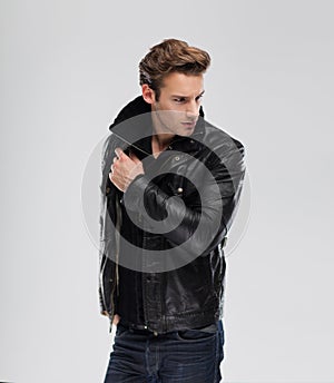 Fashion man, model leather jacket, gray background