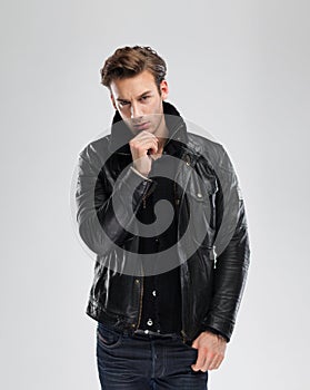 Fashion man, model leather jacket, gray background