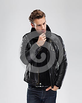 Fashion man, model leather jacket, gray background
