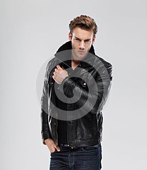 Fashion man, model leather jacket, gray background