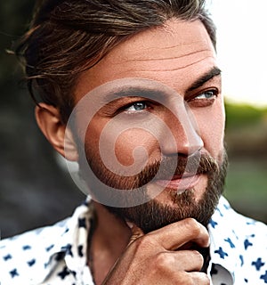 Fashion man model wearing white shirt clothes posing on the street background