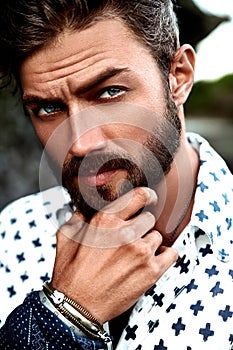 Fashion man model wearing white shirt clothes posing on the street background