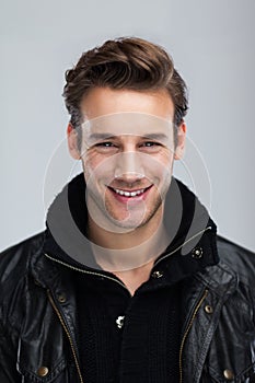 Fashion man smile face close up gray background