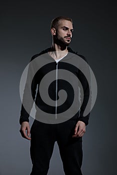 Fashion man wearing gym suit and looking to side
