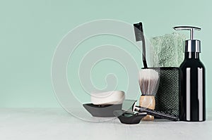 Fashion men toiletry accessories in black color in green mint menthe and white interior - razor, toothbrush, towel, soap.