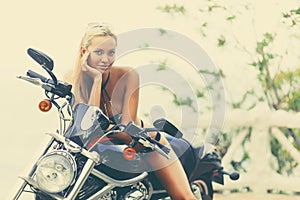 Fashion model biker girl on a motorcycle - old retro fashioned t