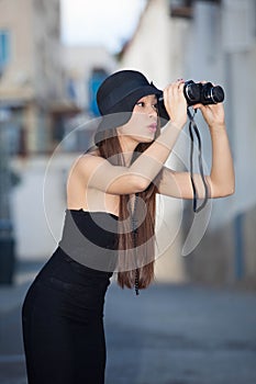 Fashion model with binoculars