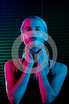 Fashion model blonde woman in colorful bright neon lights