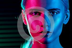 Fashion model blonde woman in colorful bright neon lights