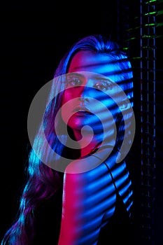 Fashion model blonde woman in colorful bright neon lights