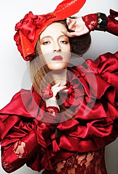 Fashion model in bright red costume and red hat